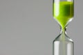 Diminishing green. Green sand of hour glass Royalty Free Stock Photo