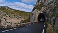 Diminishing perspective of country road D942 above canyon Gorges de la Nesque in Provence region, France with dark tunnel. Royalty Free Stock Photo