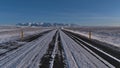 Diminishing perspective of icy paved ring road in the south of Iceland near JÃÂ¶kulsÃÂ¡rlÃÂ³n on sunny day in winter. Royalty Free Stock Photo