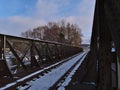 Iron railway bridge crossing Danube River in Sigmaringen, Baden-WÃÂ¼rttemberg, Germany with bare trees on sunny winter day. Royalty Free Stock Photo