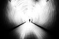 Diminishing perspective of unrecognizable man in a bright public tunnel