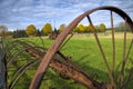 Diminishing perspective view of an old farm machine on the field Royalty Free Stock Photo
