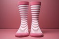 Diminutive socks against a rosy surface, poised for your affectionate missive