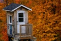 Diminutive wooden guard tower in the midst of a vibrant autumnal landscape