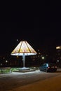 DIMITROVGRAD, BULGARIA - DECEMBER 23, 2017: Giant bedside lamp, a car next to it and the moon in the sky at Maritsa Park Royalty Free Stock Photo