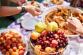 Buffet in the open air. Fresh fruits and traditional Uzbek cuisine. Dimlama - stewed vegetables with the meat in a large Royalty Free Stock Photo