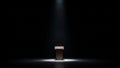 Dimly lit podium under spotlight in dark space Royalty Free Stock Photo