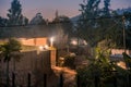 Dimly lit street scene among houses in Nyamirambo, an outlying s