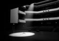 A dimly lit theater interior with multiple seating balconies Royalty Free Stock Photo