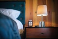 dimmable halogen lamp on a dark wood bedside table