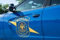 Dimondale MI - June 4, 2022: State of Michigan police coat of arms on squad car