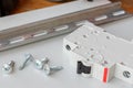 DIN rail, circuit breaker and the screws on the mounting plate Royalty Free Stock Photo