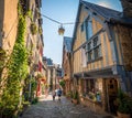 Colorful half-timbered houses and shops along historical street in Dinan.