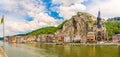 Panoramic view at the enbankment of Meuse river with houses and church of Our Lady in Dinant - Belgium