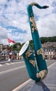 Closeup of continent themed saxophone statue, Dinant, Belgium