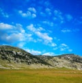 Dinara mountain over blue clouds 1 Royalty Free Stock Photo