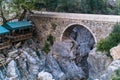 Diner gazebo for tourists next to the ancient Roman bridge over a shady gorge in the Kesme Bogazi canyon, Turkey Royalty Free Stock Photo