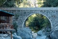 Diner gazebo for tourists next to the ancient Roman bridge over a shady gorge in the Kesme Bogazi canyon, Turkey Royalty Free Stock Photo