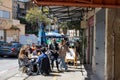 Diners enjoy their meals at a cafe adjacent to the bustling Talpiot market