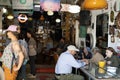 Diners enjoy their meals at a cafe adjacent to the bustling Talpiot market