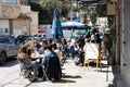 Diners enjoy their meals at a cafe adjacent to the bustling Talpiot market