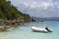 Dinghy anchored by shore