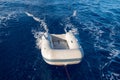 Dinghy (or dingey) inflatable small boat towed by a yacht in the