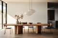 A dining area featuring a minimalist wooden table, modern dining chairs, and a statement pendant light. Royalty Free Stock Photo