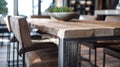 In the dining area a sleek reclaimed wood table is paired with a set of contemporary chairs. The knots and uneven edges