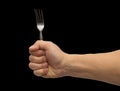 Dining fork in hand on a black background Royalty Free Stock Photo