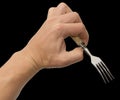 Dining fork in hand on a black background Royalty Free Stock Photo