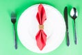 Dining napkin with gold napkin ring on green background Royalty Free Stock Photo