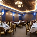 A dining room with blue walls and white tablecloths