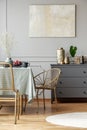 Dining room interior with small table and golden chairs Royalty Free Stock Photo