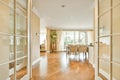 a dining room and living room with white glass doors Royalty Free Stock Photo