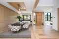 Dining room with modern light wood cabinets and upholstered dining table