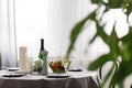 Dining room table with, champagne, candles and salad, set for anniversary dinner Royalty Free Stock Photo