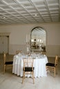 a dining room table set for four with place settings and candles Royalty Free Stock Photo