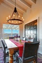 Dining room table with water view and antique iron chandelier.