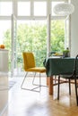 Dining room table with yellow and black chairs , real photo