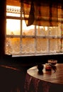 Veranda in summer house at countryside sunset in golden hour, cozy rustic mood with warm light and dark shadows Royalty Free Stock Photo