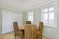 Dining room with wooden table and rattan chairs Royalty Free Stock Photo