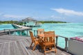 Dining setup with wooden tables and chairs at the restaurant near the ocean at Maldives Royalty Free Stock Photo