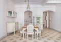 Interior of dining room with a table served for two persons. Refurbished apartment in Barcelona decorated in retro style Royalty Free Stock Photo