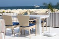 Dining table and chairs on the beach Royalty Free Stock Photo