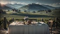 Dining table and chairs rest gracefully against a picturesque backdrop of rolling fields, charming houses, mountains.