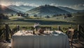 Dining table and chairs rest gracefully against a picturesque backdrop of rolling fields, charming houses, mountains, and a sun