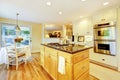 Dining table with classic kitchen yellow walls interior with hardwood floor.