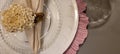 dining table decorated with flowers and pink napkins