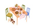 Dining table after dinner party with pizza, drink. Food scraps, leftovers on plates, snacks, beverages and cute dog